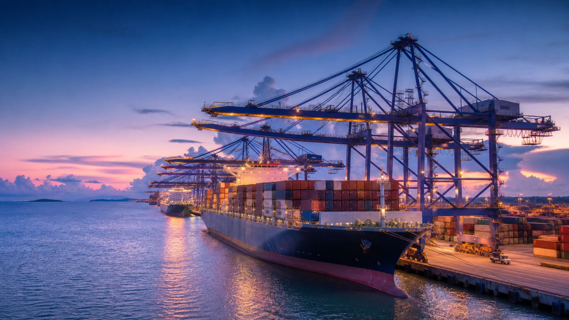 Container ship loading beneath cranes at a modern international port