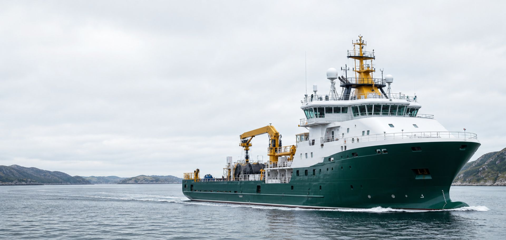 Modern offshore service vessel underway in northern coastal water