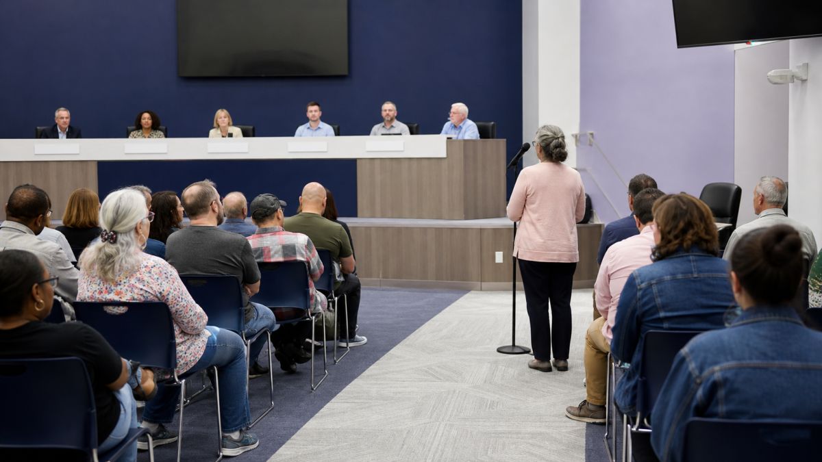 Wide view of a resident speaking during a public council meeting