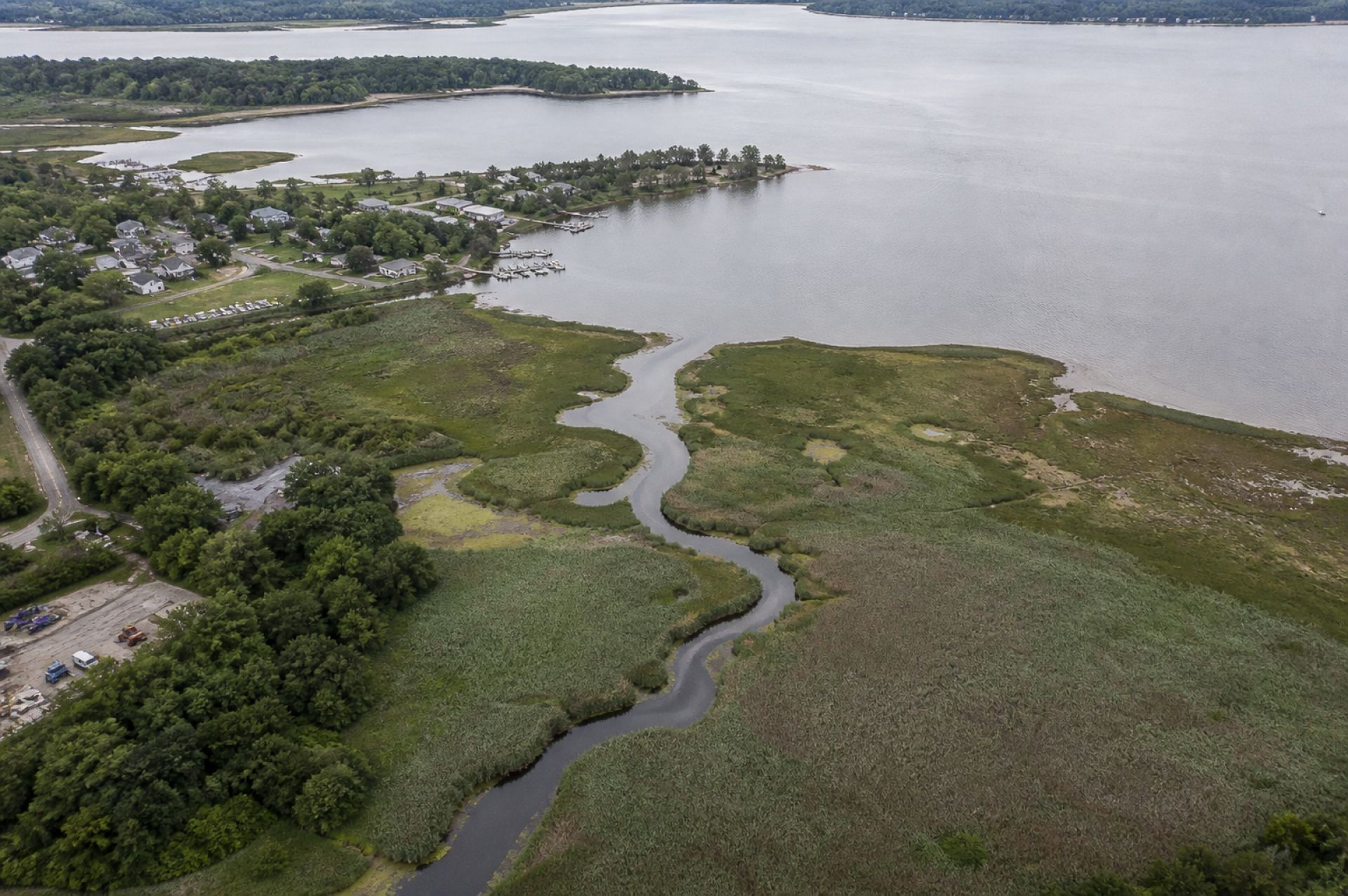 Aerial view of a river inlet, wetland channels and coastal basin